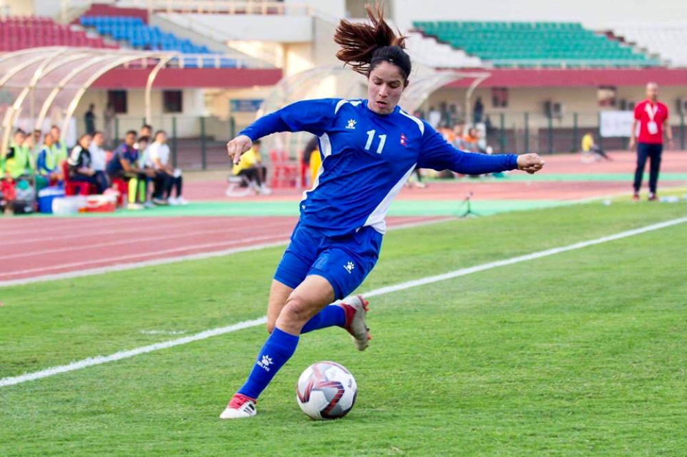 National player playing grass ball