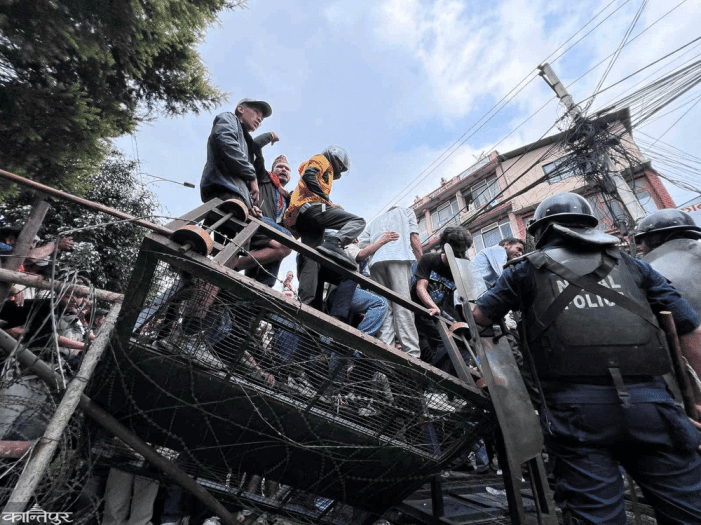 Jen-ji is tear gassed by the police after breaking the restricted area
