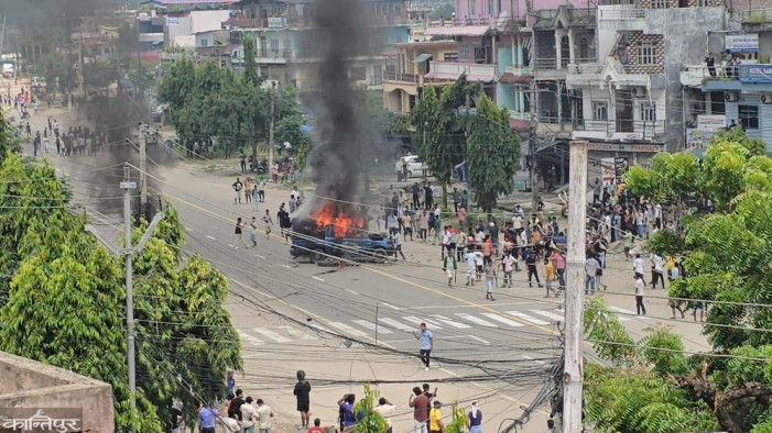 Protesters set fire to a police car in Chandranigahpur, firing