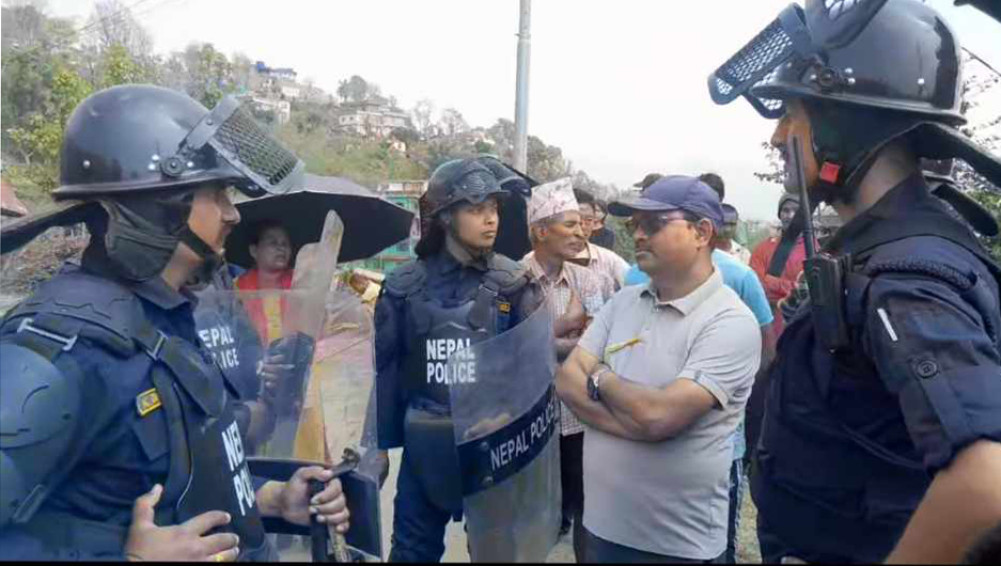 Obstructed by local people to install electric pole, 12 policemen under control