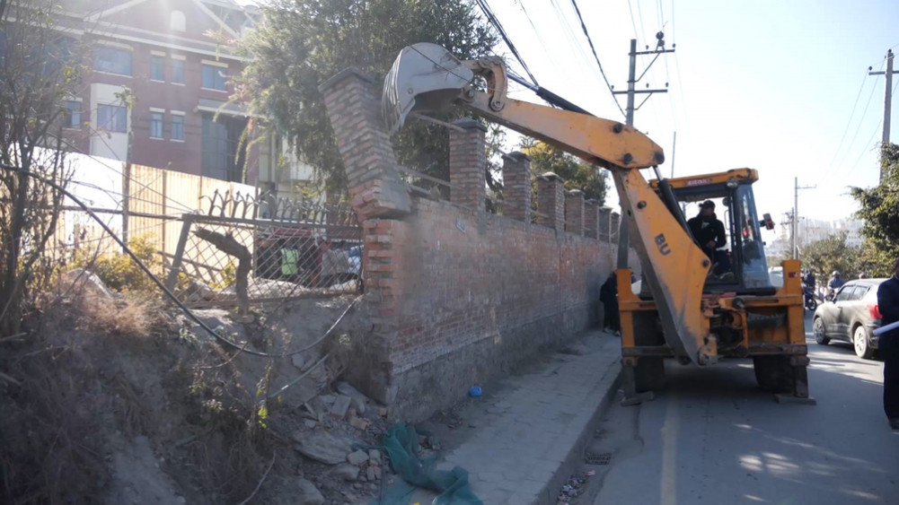 The dozer ran on the buildings built by encroachment on government land