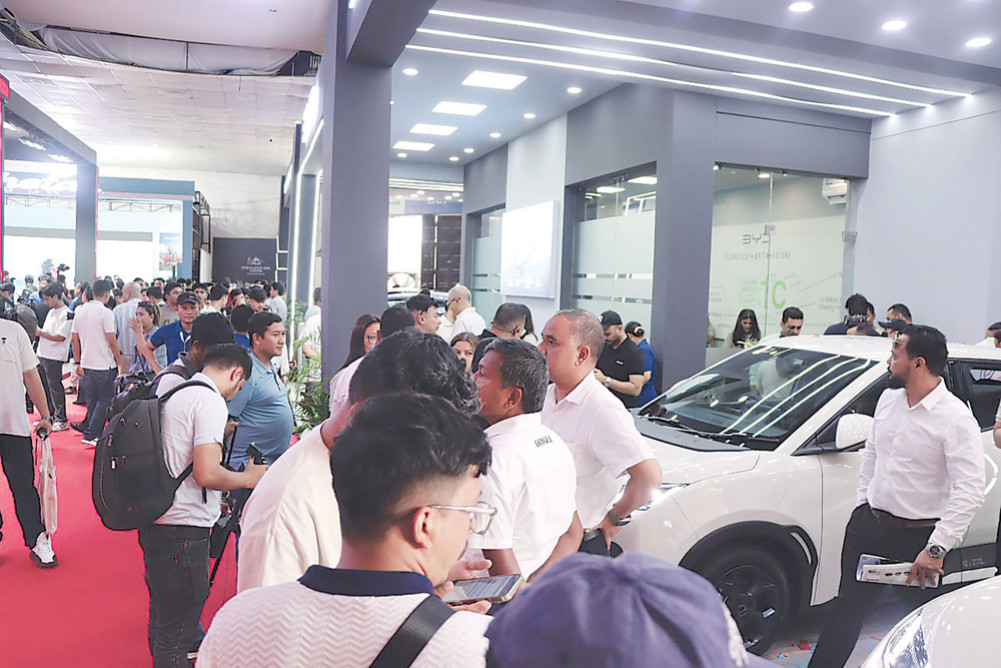 Onlookers gather to see the new car at the Naima Expo