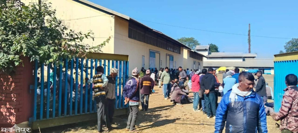 Food depot collecting coupon money from farmers who have arrived to sell rice