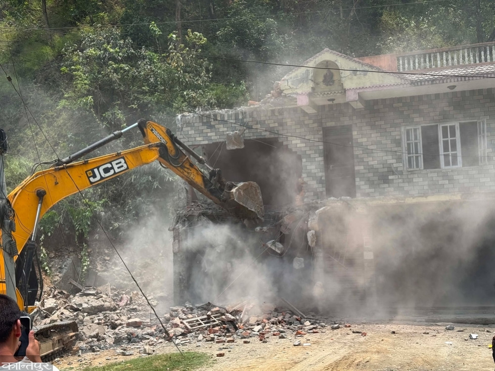 Bulldozer on commercial building for encroaching on forest land