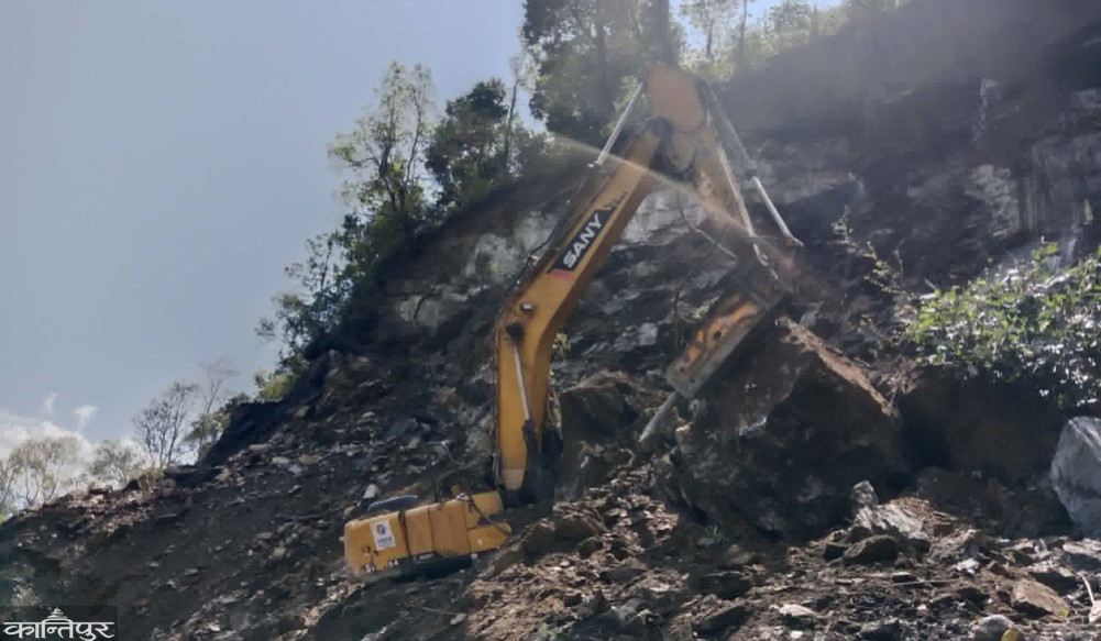 Driver buried with excavator while digging road