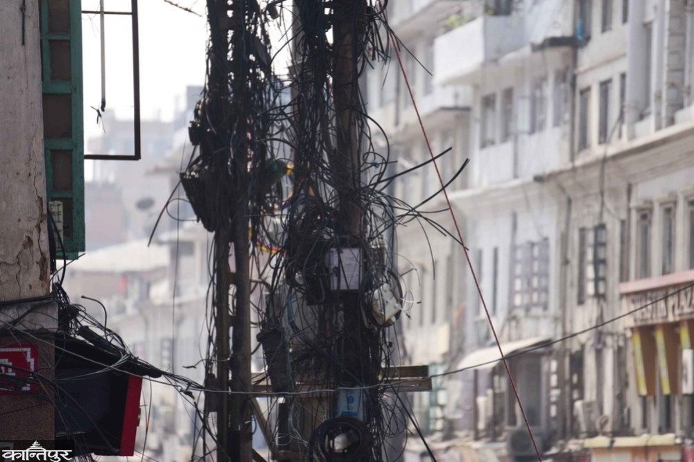 There are still wires hanging from the streets of Kathmandu.