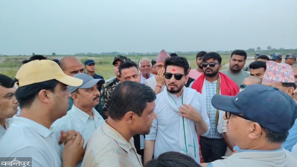 Infrastructure Minister Lamsal and contractor surrounded by locals at Kamala River